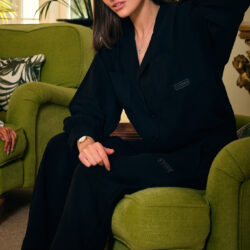 Cotone Collection woman on sofa in black pyjamas - Luxury Sleepwear & pyjamas
